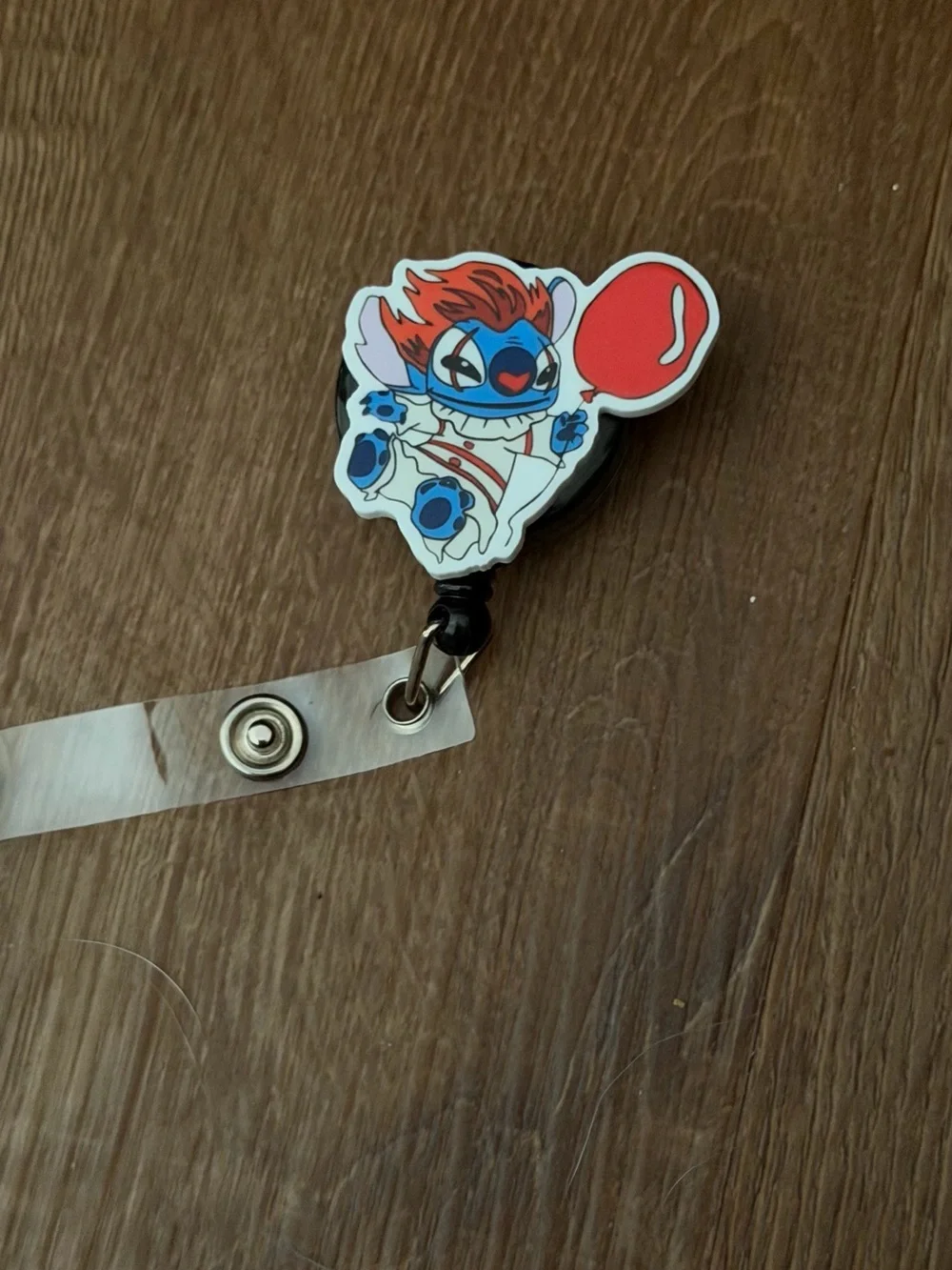 Blue Cartoon Character Badge Reel with Red Balloon